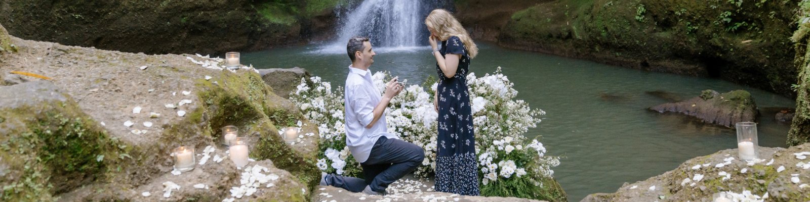 Jonathan proposing to Rebecca beside a waterfall